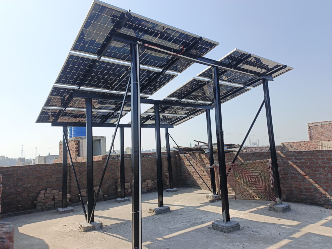 Side angle of elevated solar rooftop structure over Lahore terrace